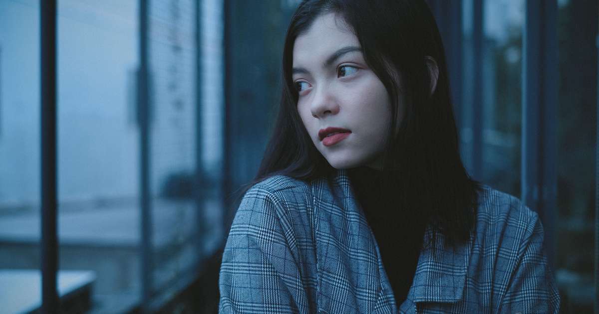 A university student looks out over an unfamiliar city, reflecting the adjustment of studying abroad