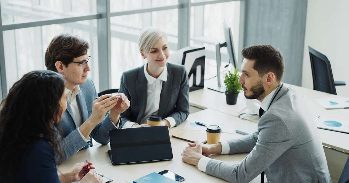 A leadership team in discussion around a table during a period of organizational change