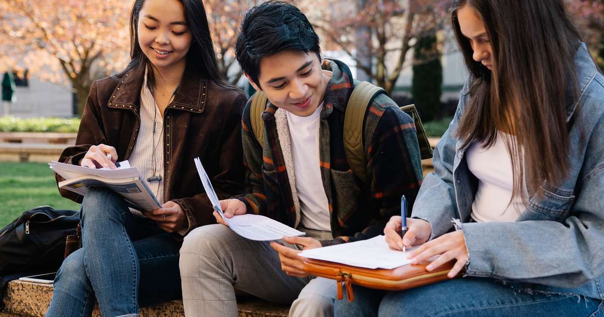 students studying outside university campus